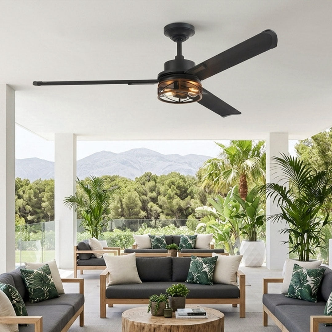 Black ceiling fan with lighting installed above a covered patio with modern outdoor seating.