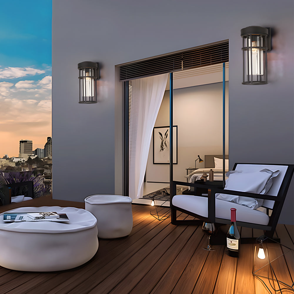 Contemporary patio space with cage-style wall sconces mounted on exterior walls at twilight