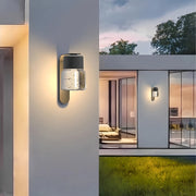 Contemporary exterior wall mount lights illuminating a modern patio area at dusk.