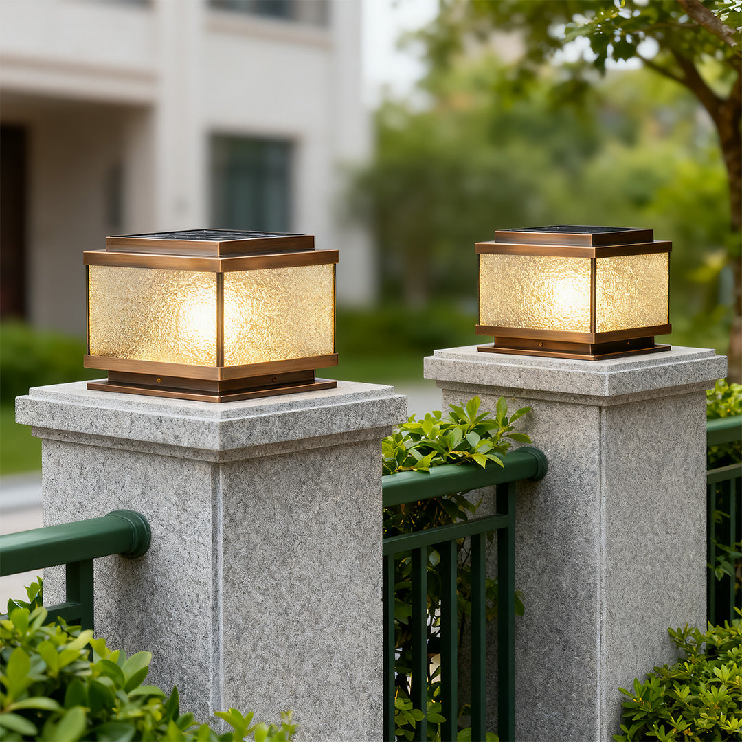 Garden pillar light on blue stone post with warm glow enhancing outdoor patio ambiance