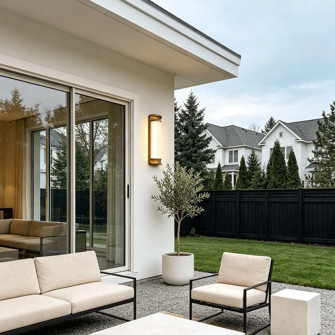 LED outdoor wall sconces mounted beside a patio creating warm exterior illumination.