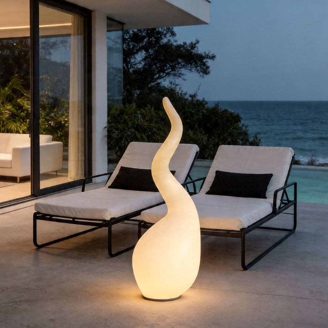 Patio outdoor floor lamps illuminating luxury poolside lounge area with artistic glowing sculpture design.