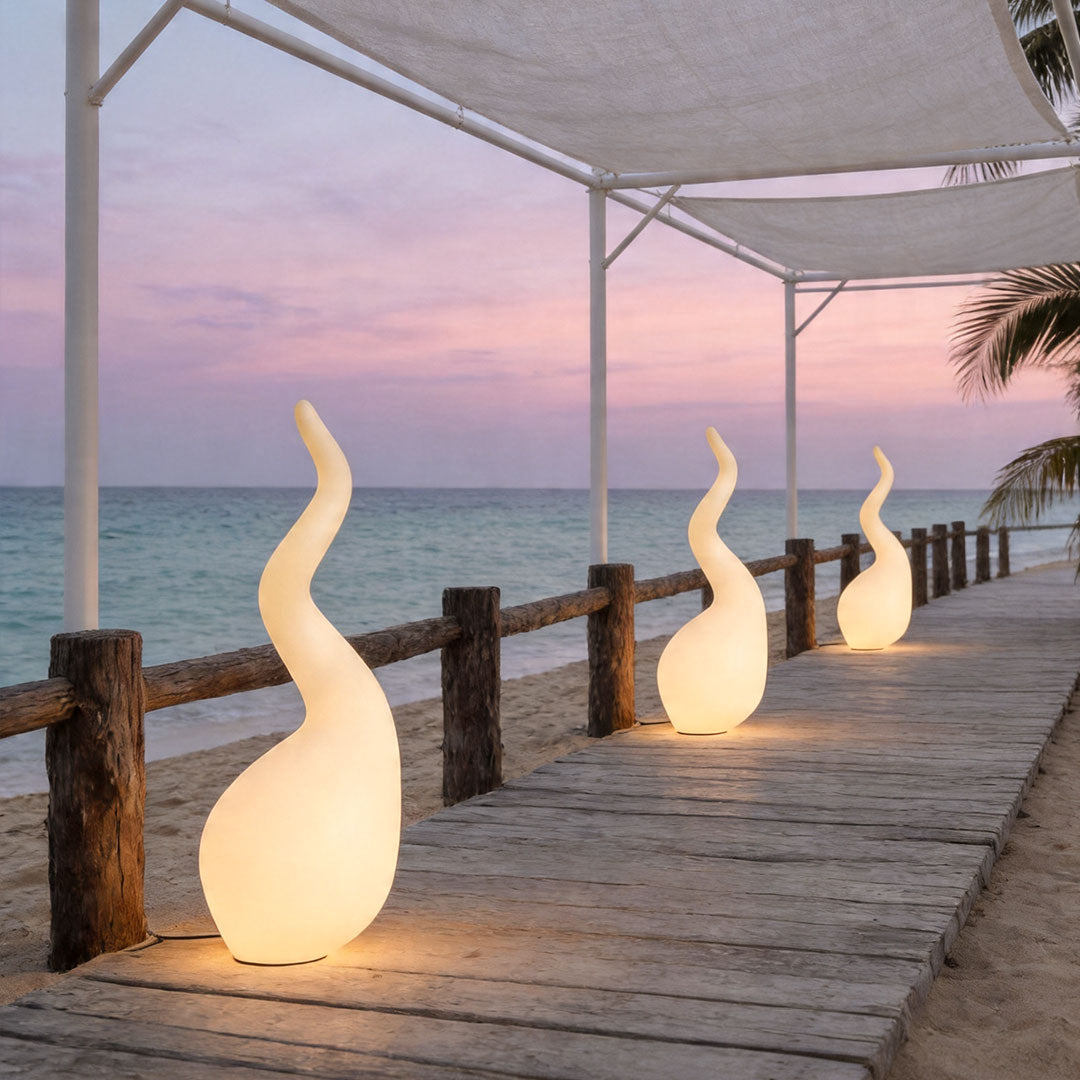 Patio outdoor floor lamps arranged along wooden boardwalk with elegant sculptural outdoor illumination.