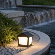 Patio pillar lights illuminating a modern garden pathway with warm ambient glow.