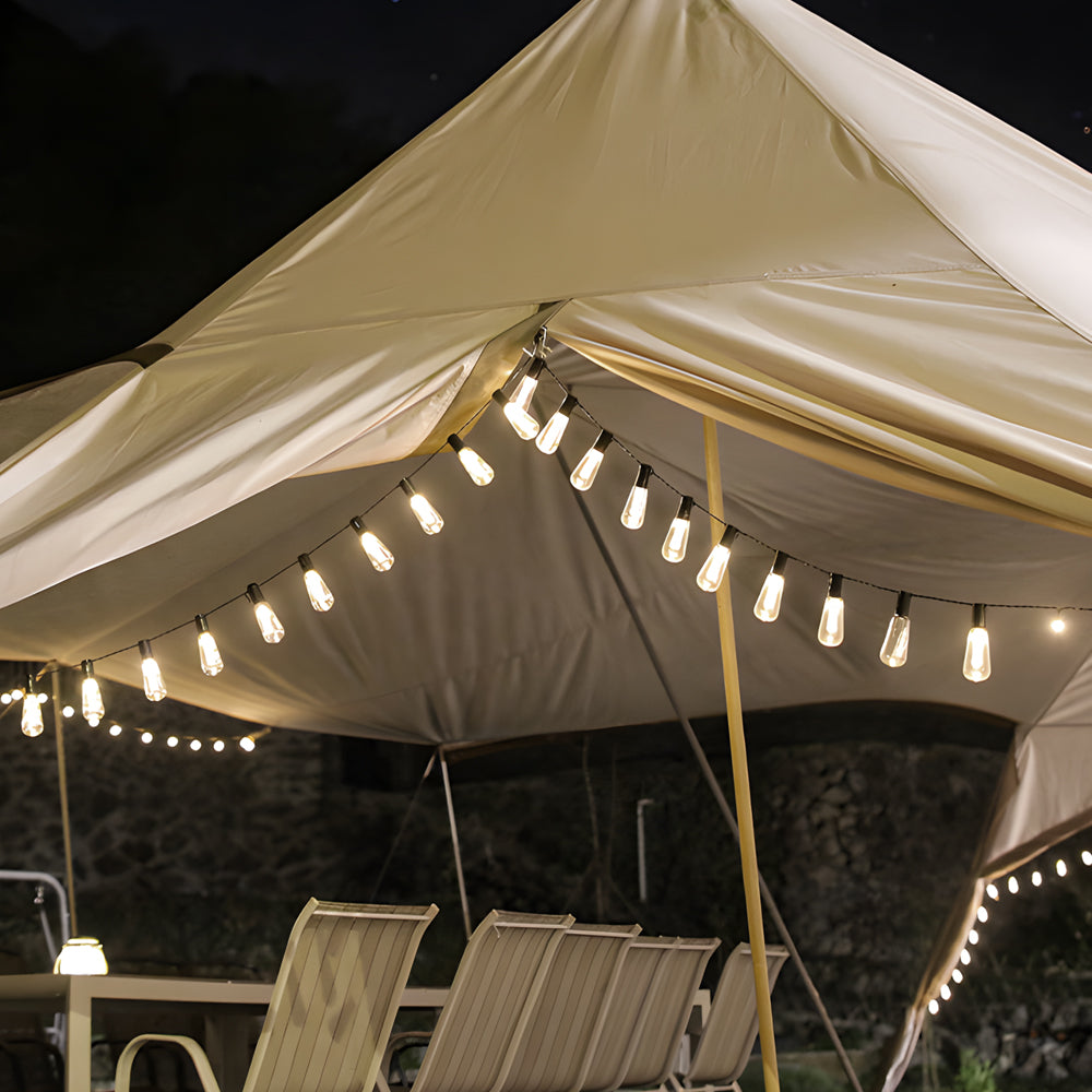 Solar camping string lights creating magical atmosphere under patio umbrella for elegant outdoor dining and entertainment space
