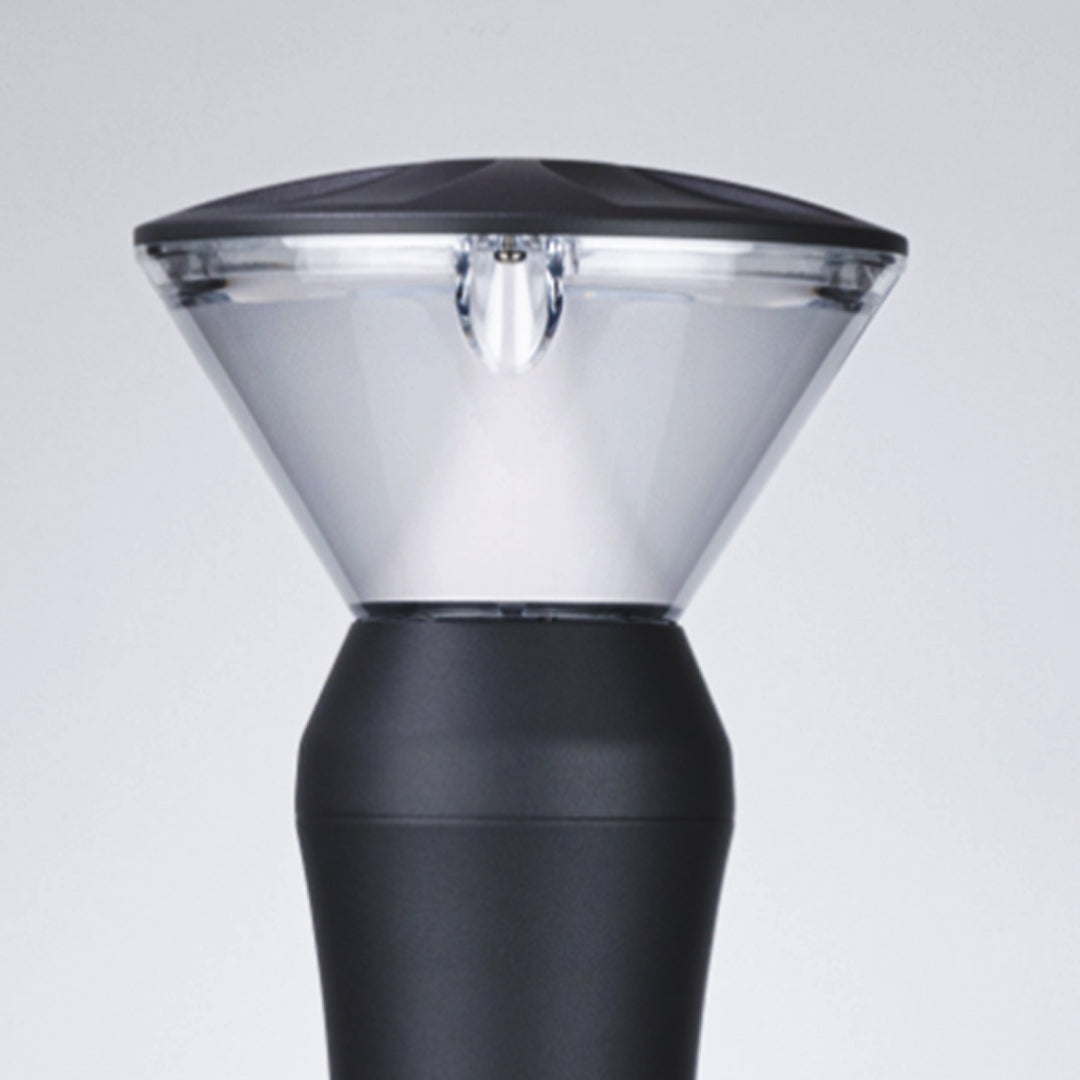Detail shot of conical light shade with black base and clear reflective top