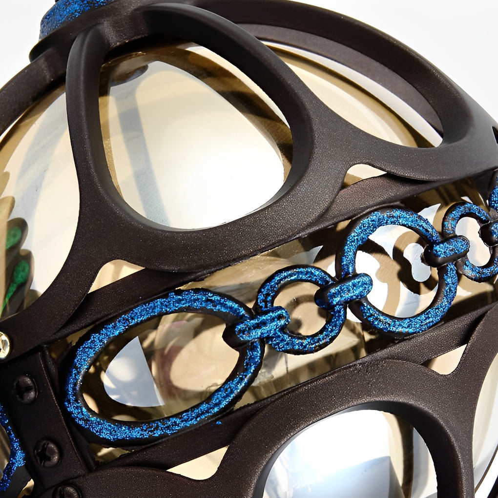 Close-up of peacock wall light lantern shade with metal detailing.