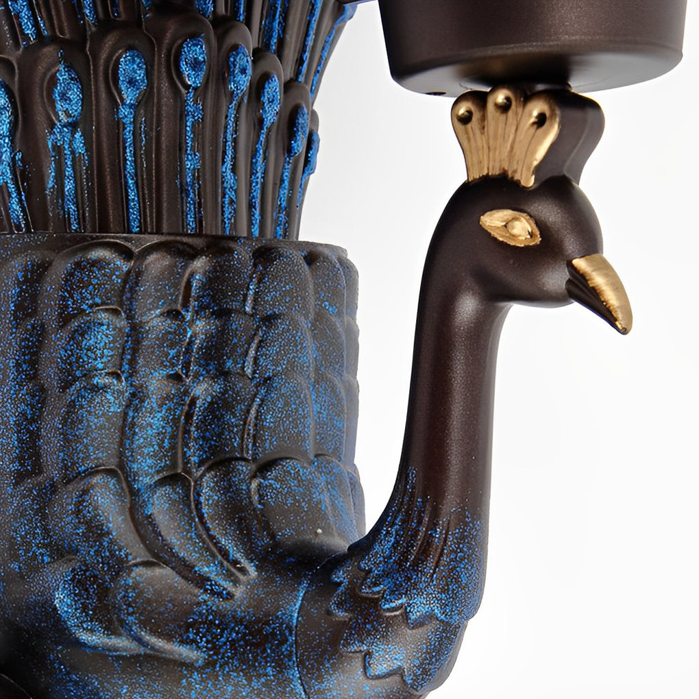 Peacock wall sconce arm detail showing sculpted bird neck design.