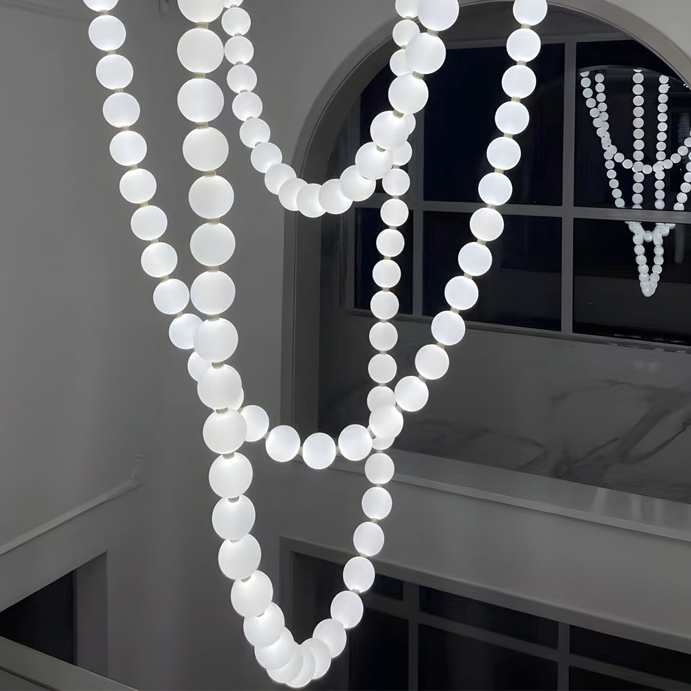 Pearl necklace light fixture with a white pearl design, hanging in a modern hallway.
