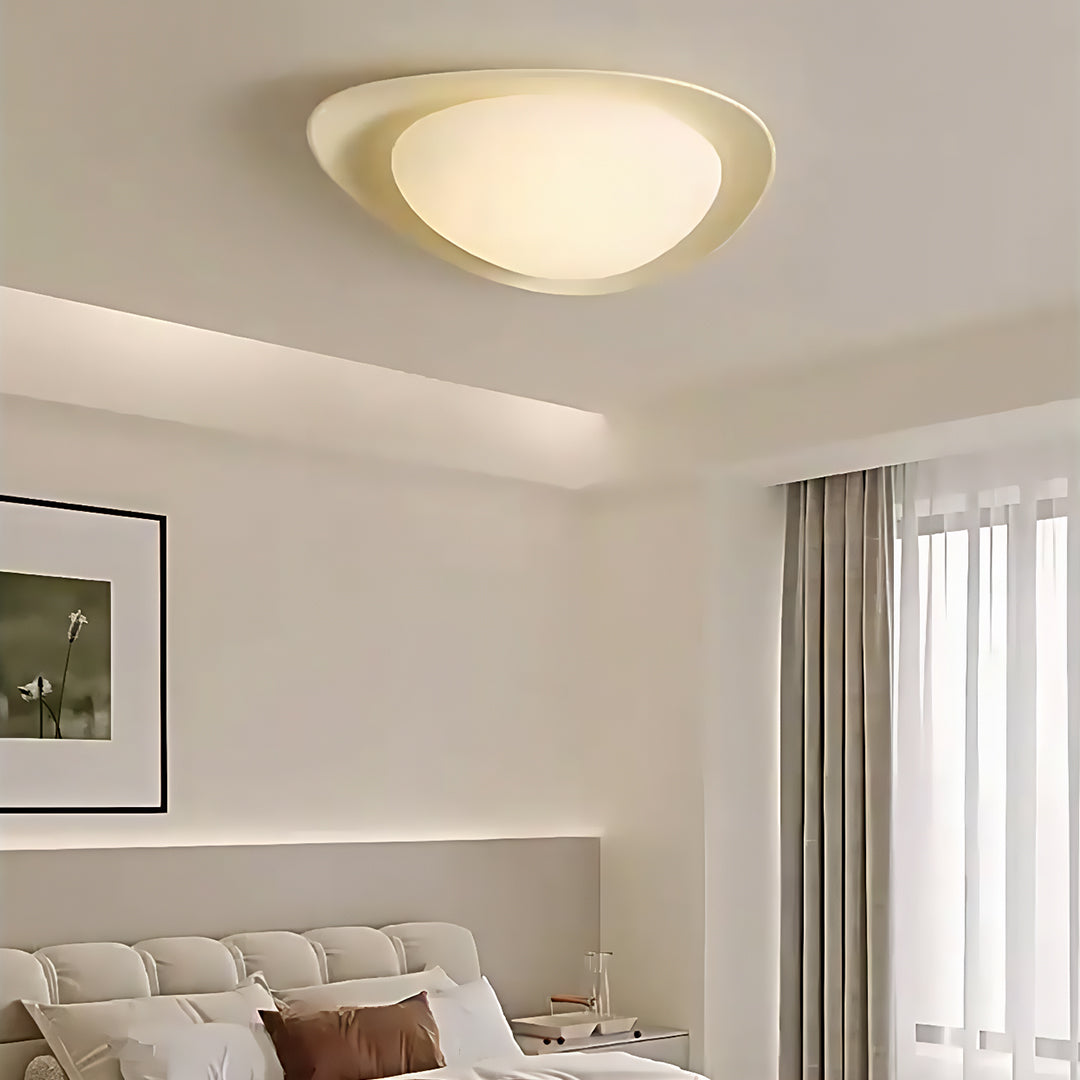 Pebble ceiling light creating soft ambient glow in contemporary bedroom with neutral decor