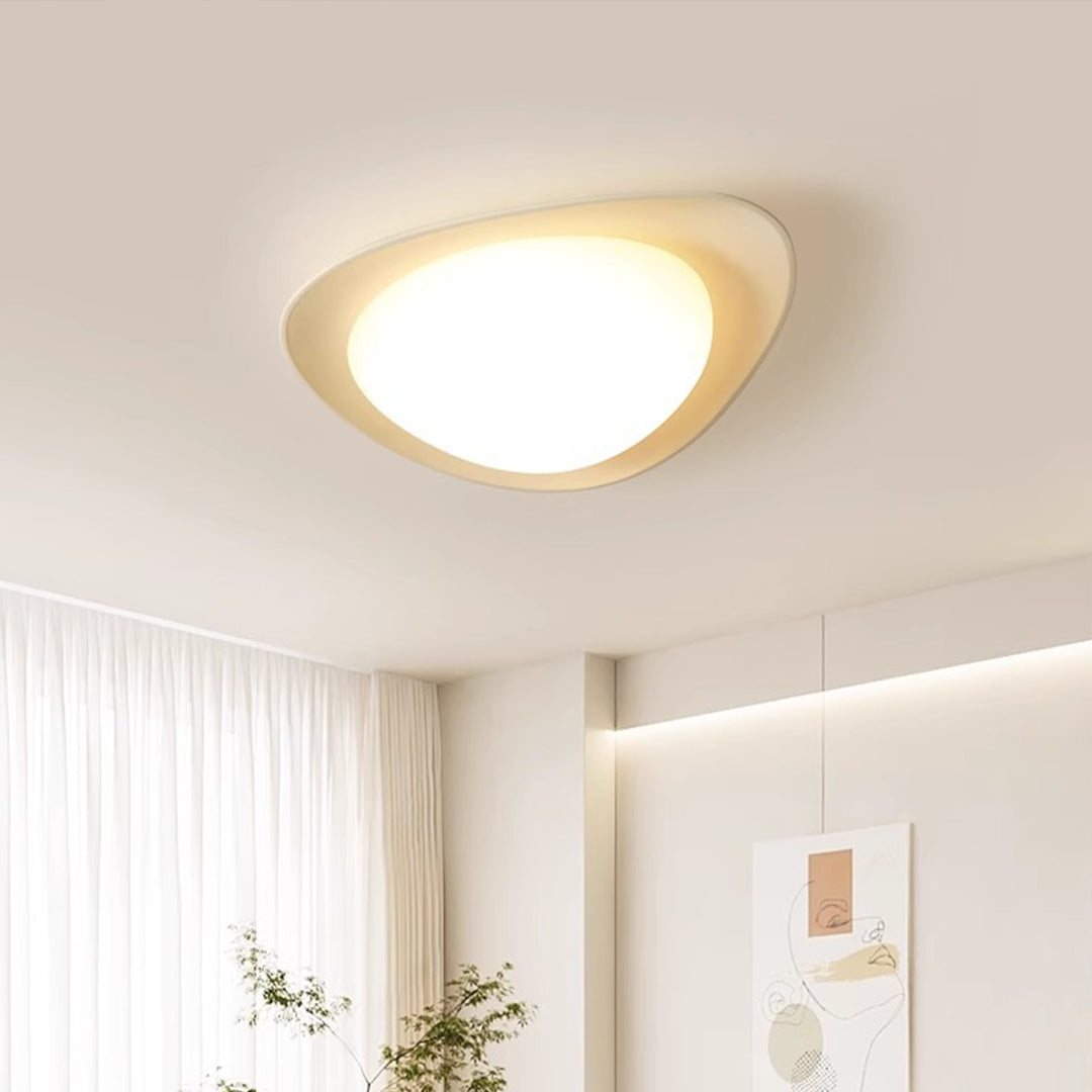 Pebble ceiling light illuminating modern living space with clean white interior design