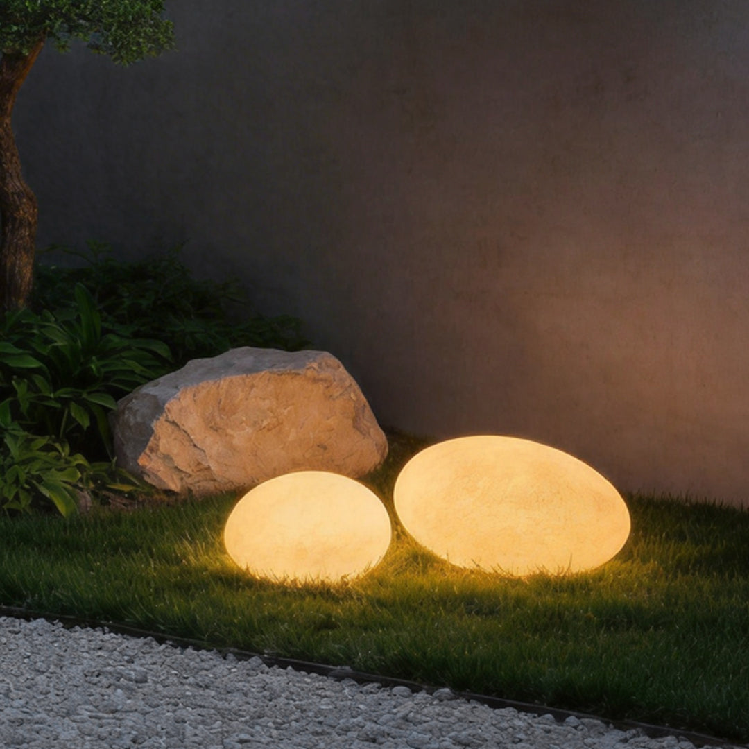 Pebble garden lights enhancing a contemporary garden area with soft directional light.