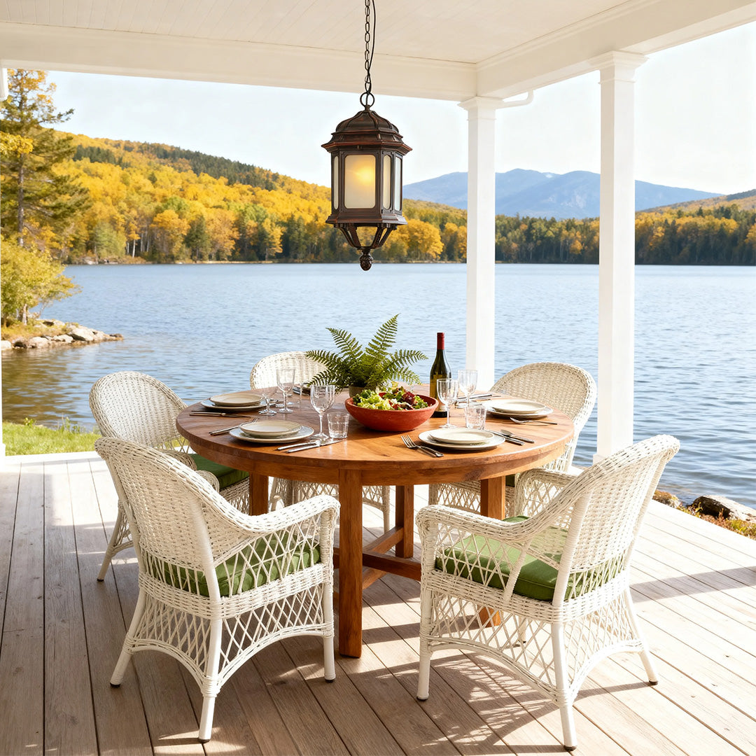 Pendant bollard LED light brightening lakeside patio dining space with wicker furniture and scenic views