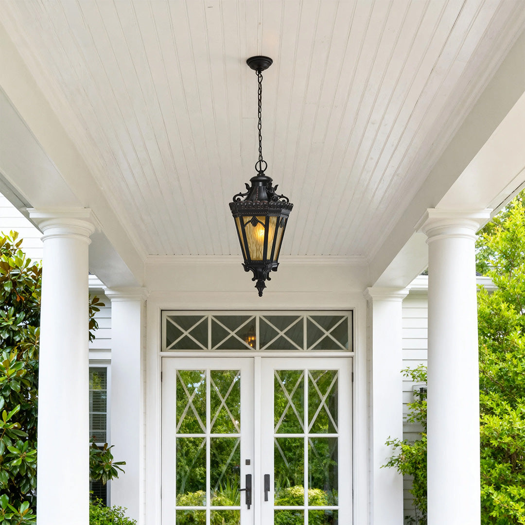 Pendant light outdoor hanging from white porch ceiling near elegant French doors and greenery