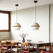 Pendant lights with fabric shades hanging above a stylish table, creating a cozy dining experience.