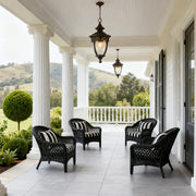 Pendant porch lights hanging from white covered veranda with wicker furniture and mountain views