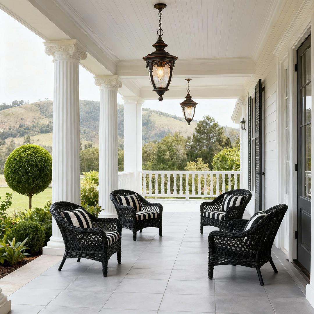 Pendant porch lights hanging from white covered veranda with wicker furniture and mountain views