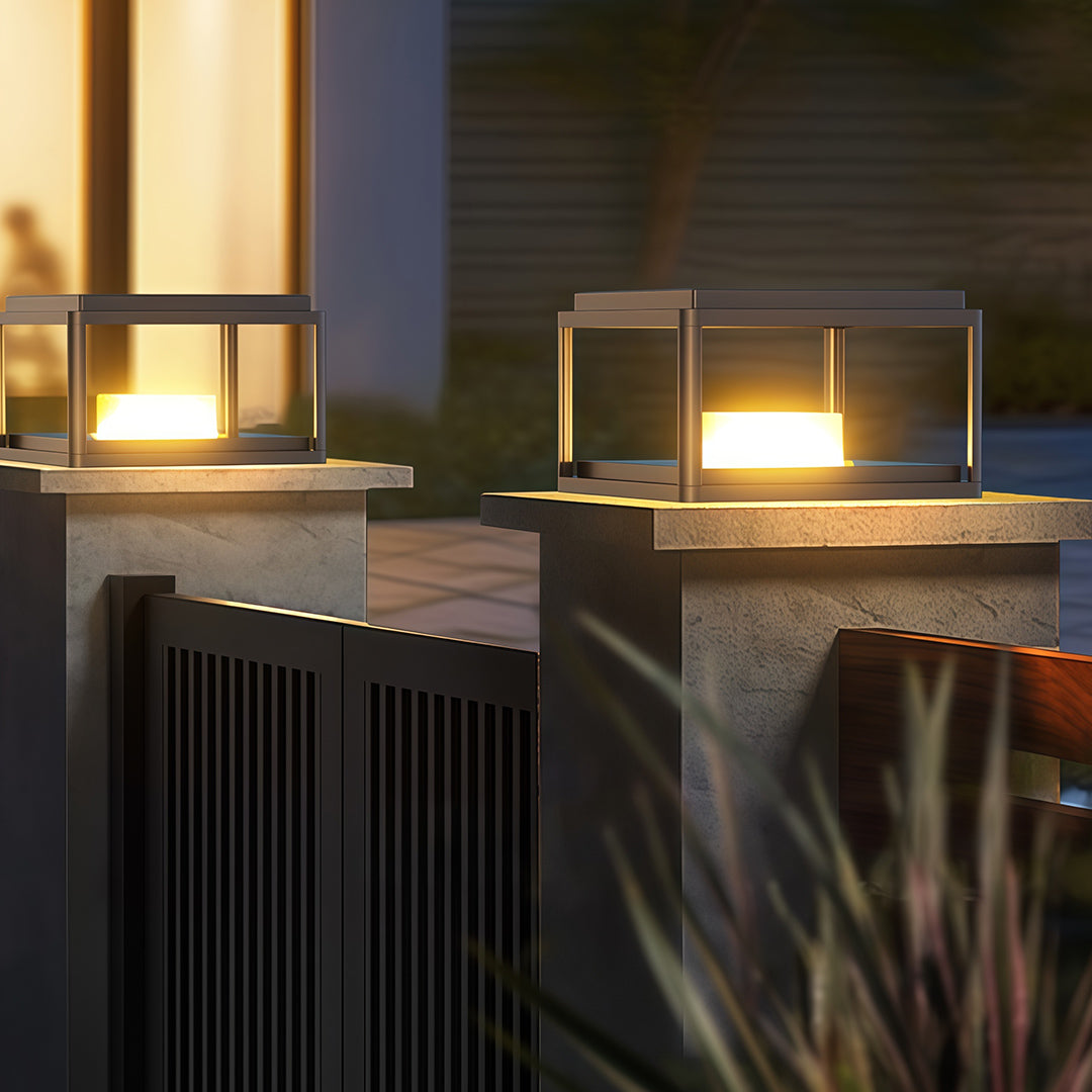 Pillar gate light installed near a driveway entrance, providing a modern and welcoming glow.