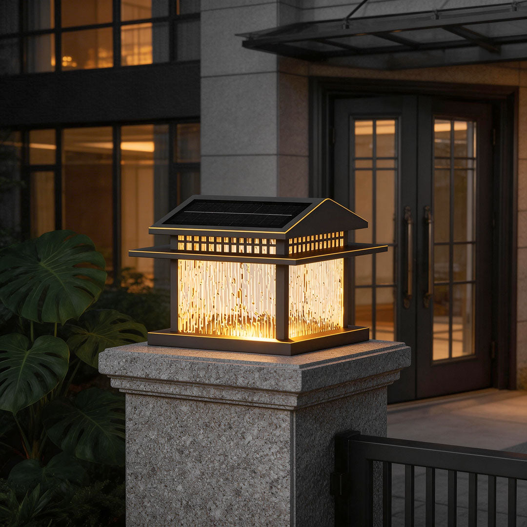 Stylish pillar lamp light with glass panels, casting a warm glow on a stone pillar.