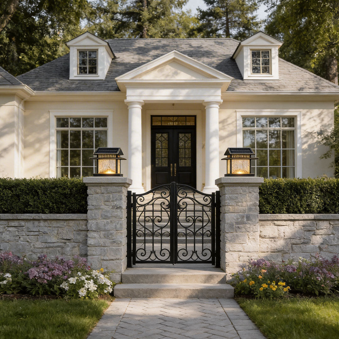 Modern pillar lamp light with warm glow at the entrance of a luxurious house with white fencing.