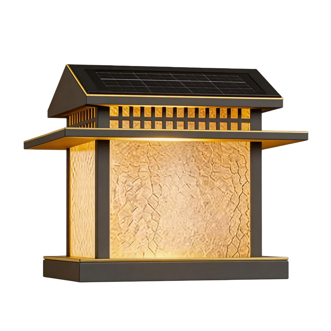 Pillar lamp light with a square design and golden accents, illuminating a garden pathway.