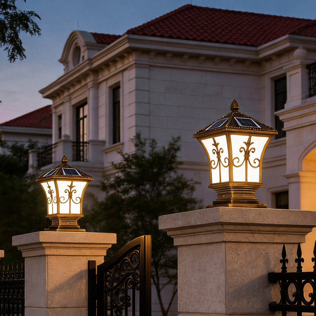Pillar lantern lights illuminating a garden pathway with warm, inviting glow at night.