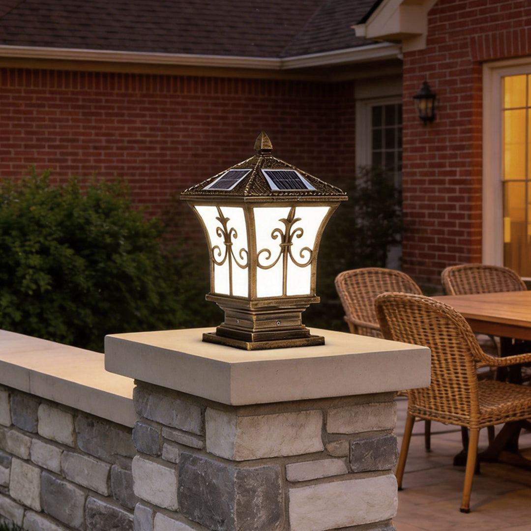 Pillar lantern lights with a vintage design, installed on a stone pillar near a modern house.