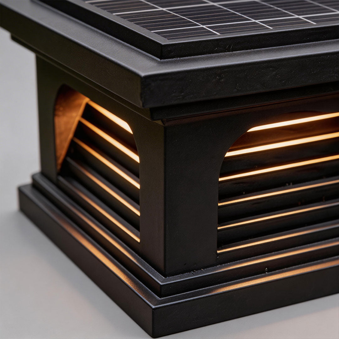 Close-up of a pillar light design outdoor with a black finish and illuminated slats.