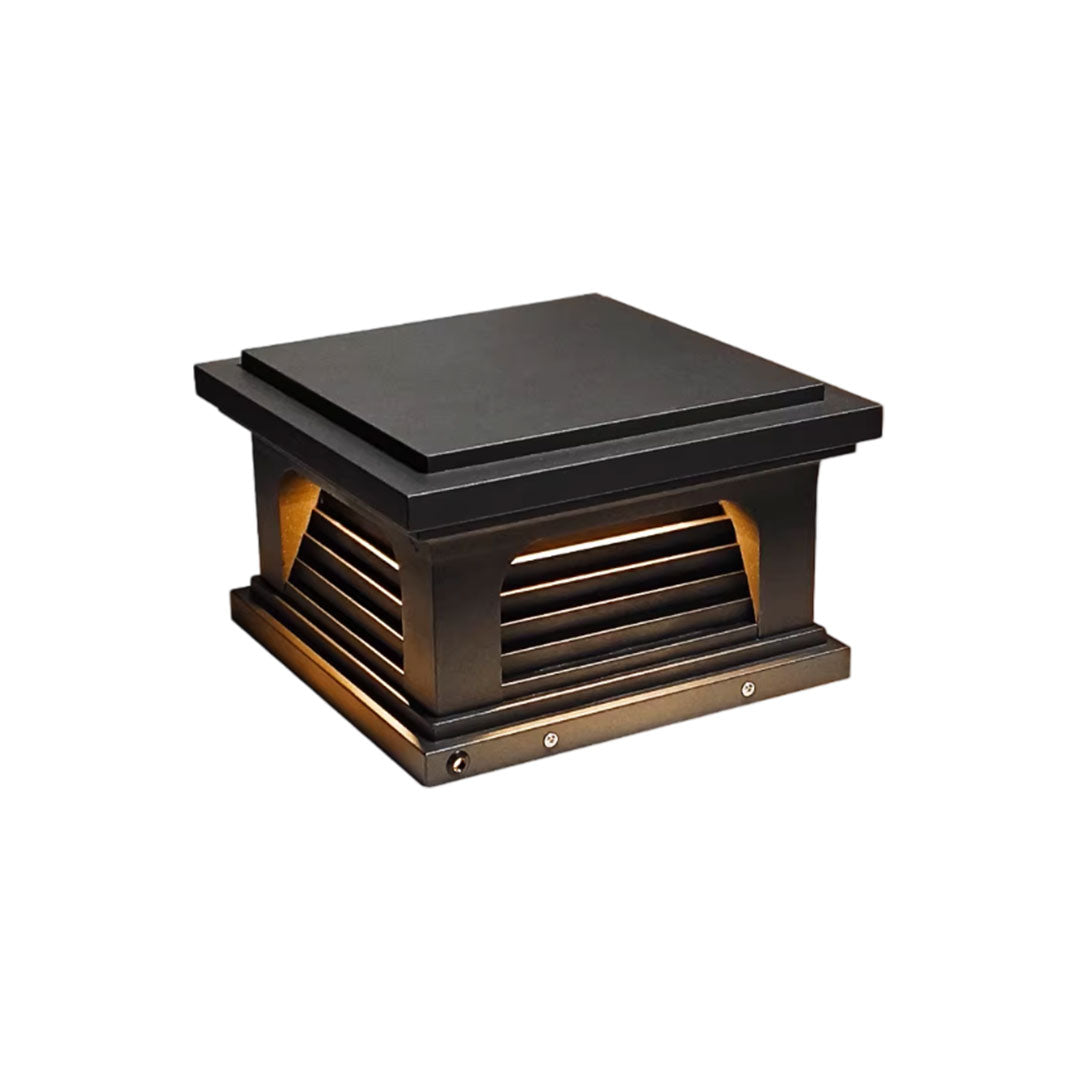 Modern pillar light design outdoor with a black metal frame and warm light emission.