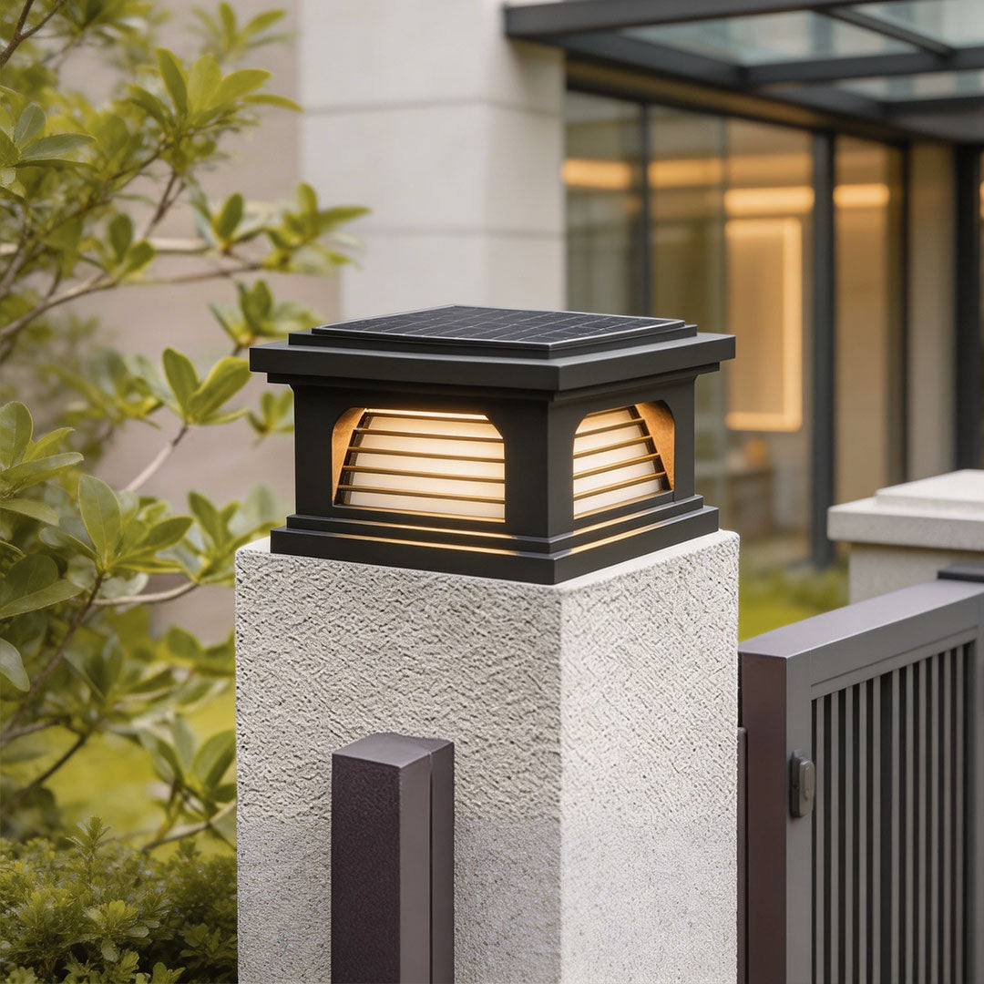 Modern pillar light design outdoor with a sleek black top, mounted on a stone pillar.