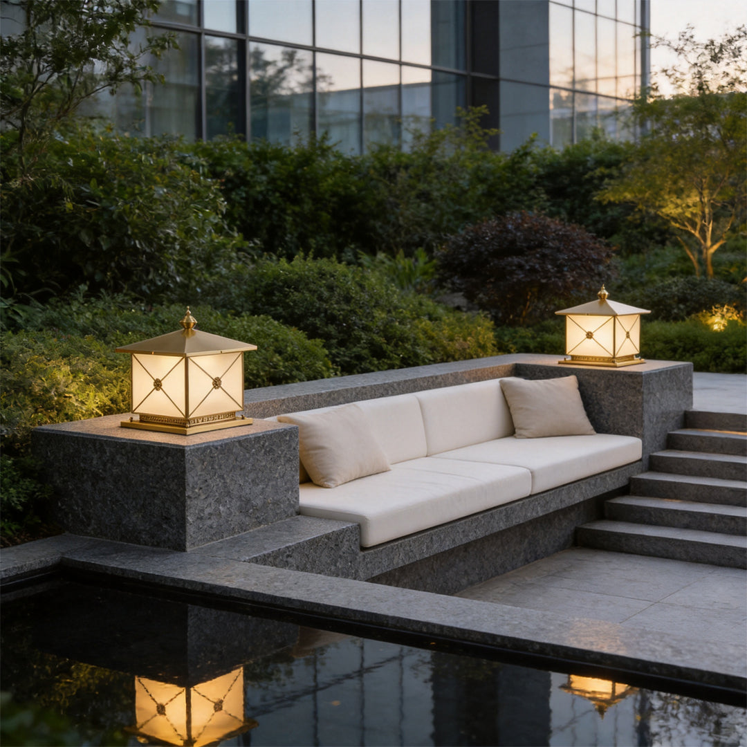 Contemporary pillar light solar placed around outdoor lounge seating with ambient evening glow.