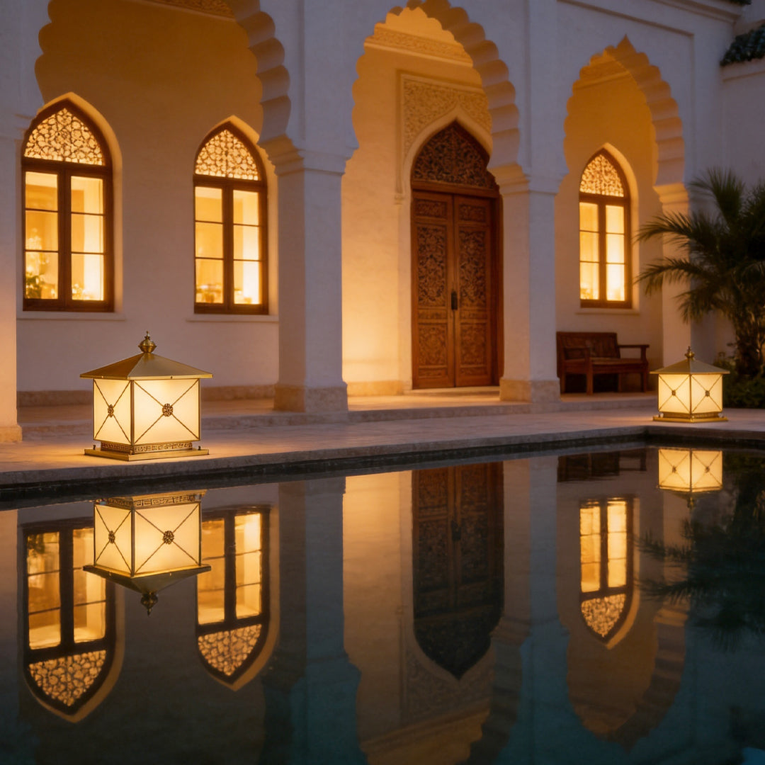 Luxury pillar light solar beside reflective pool outside a Mediterranean style villa at dusk.