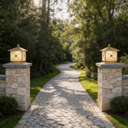 Elegant pillar light solar installed on stone entrance columns along a luxury garden pathway.