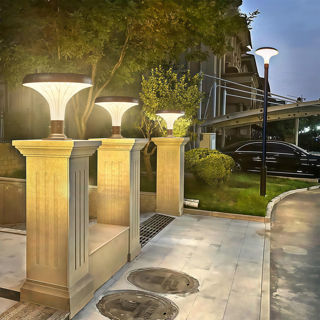 Pillar light along a walkway, casting a warm light to illuminate the garden path.