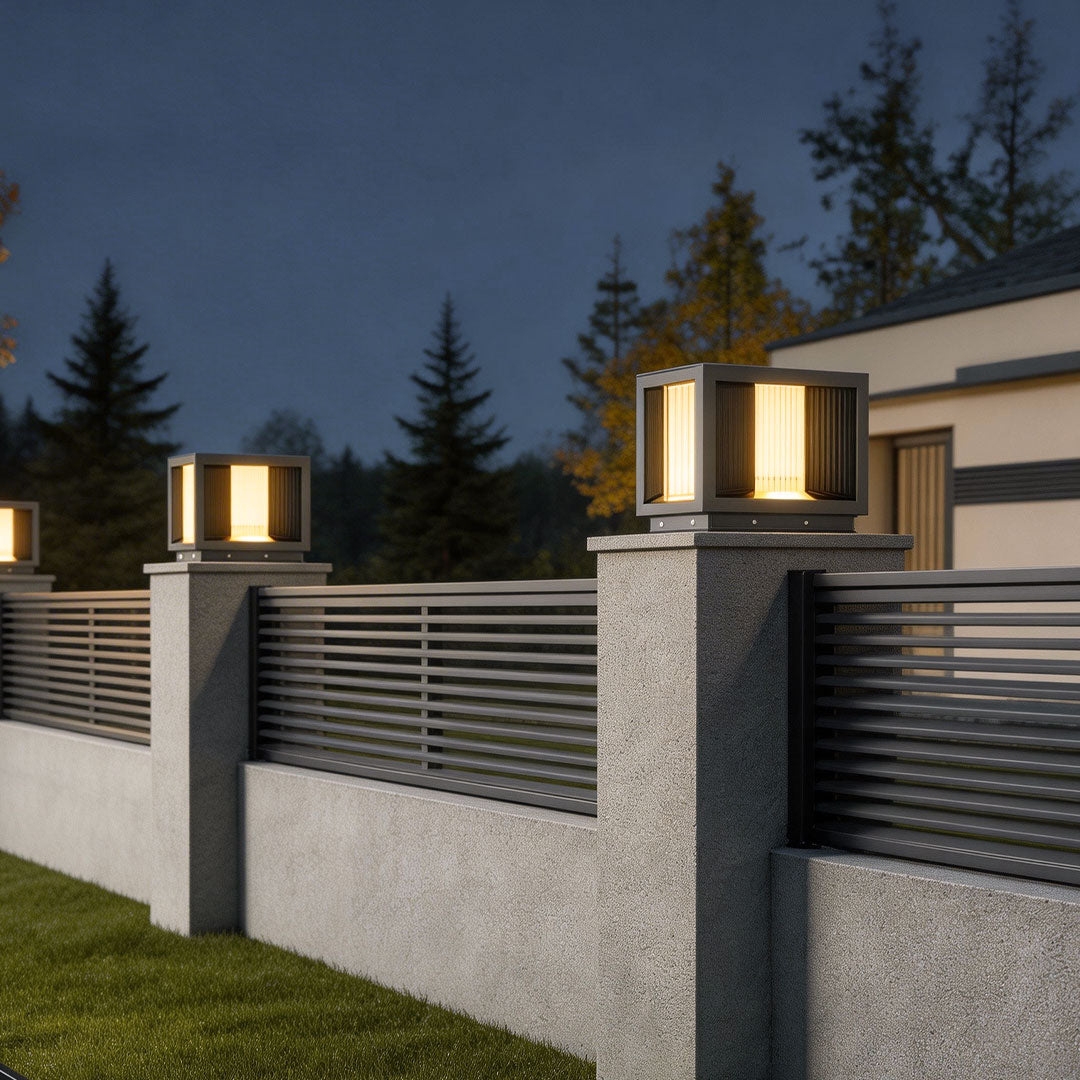 Pillar lighting illuminating a modern house entrance with sleek black design and stone pillars.