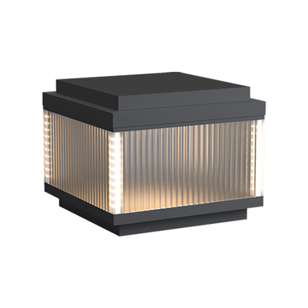 Medium-size pillar lighting outdoor fixture featuring ribbed glass panels and warm illumination.