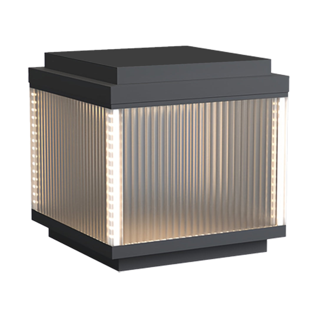 Tall pillar lighting outdoor lamp with extended ribbed glass body and a flat black top.