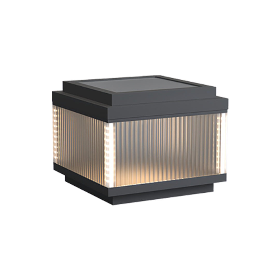 Compact pillar lighting outdoor piece with clean ribbed glass and a modern black housing.