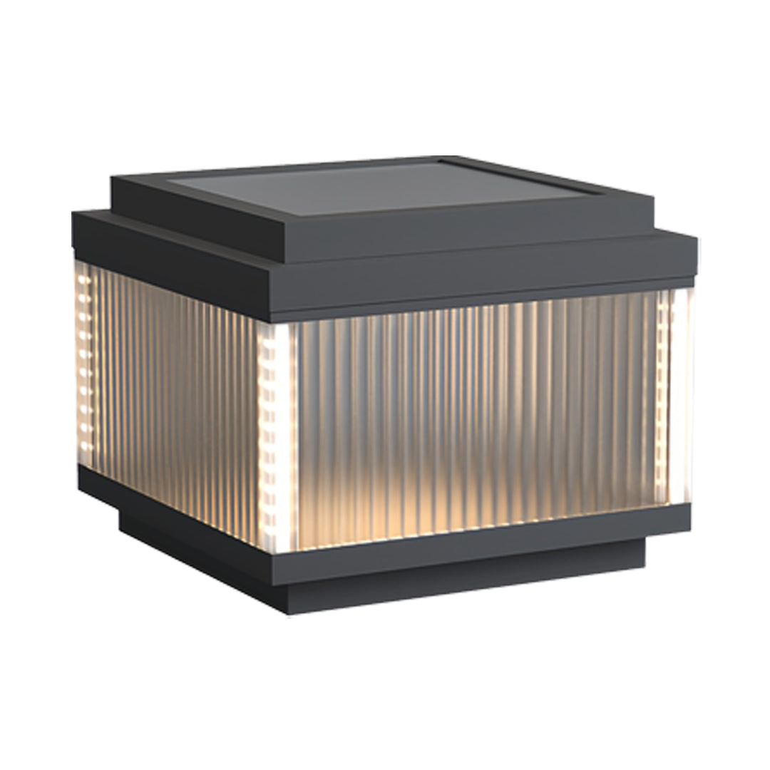 Square pillar lighting outdoor fixture with elegant ribbed glass and soft ambient illumination.
