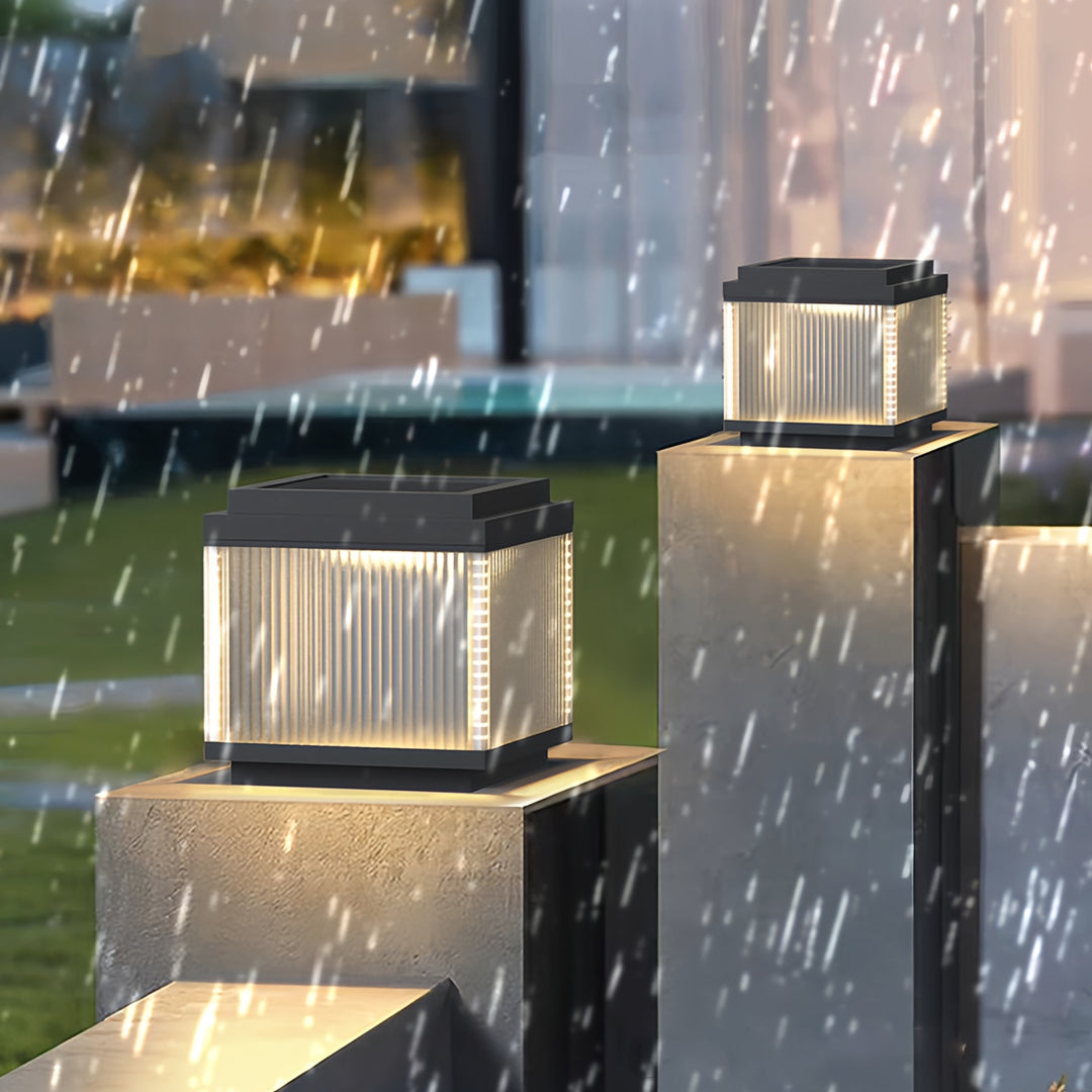 Pillar lighting outdoor fixtures used along a residential fence, showcasing soft evening illumination.