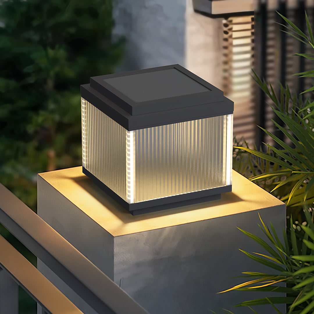 Contemporary pillar lighting outdoor fixtures highlighting a landscaped garden entrance.