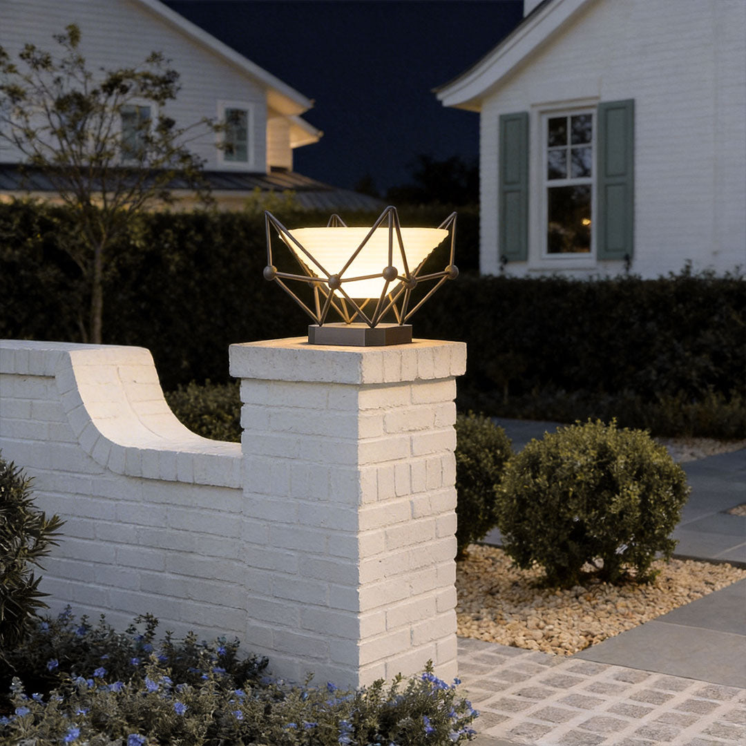 Stylish pillar lights for garden mounted on a white brick wall, providing warm ambient lighting.