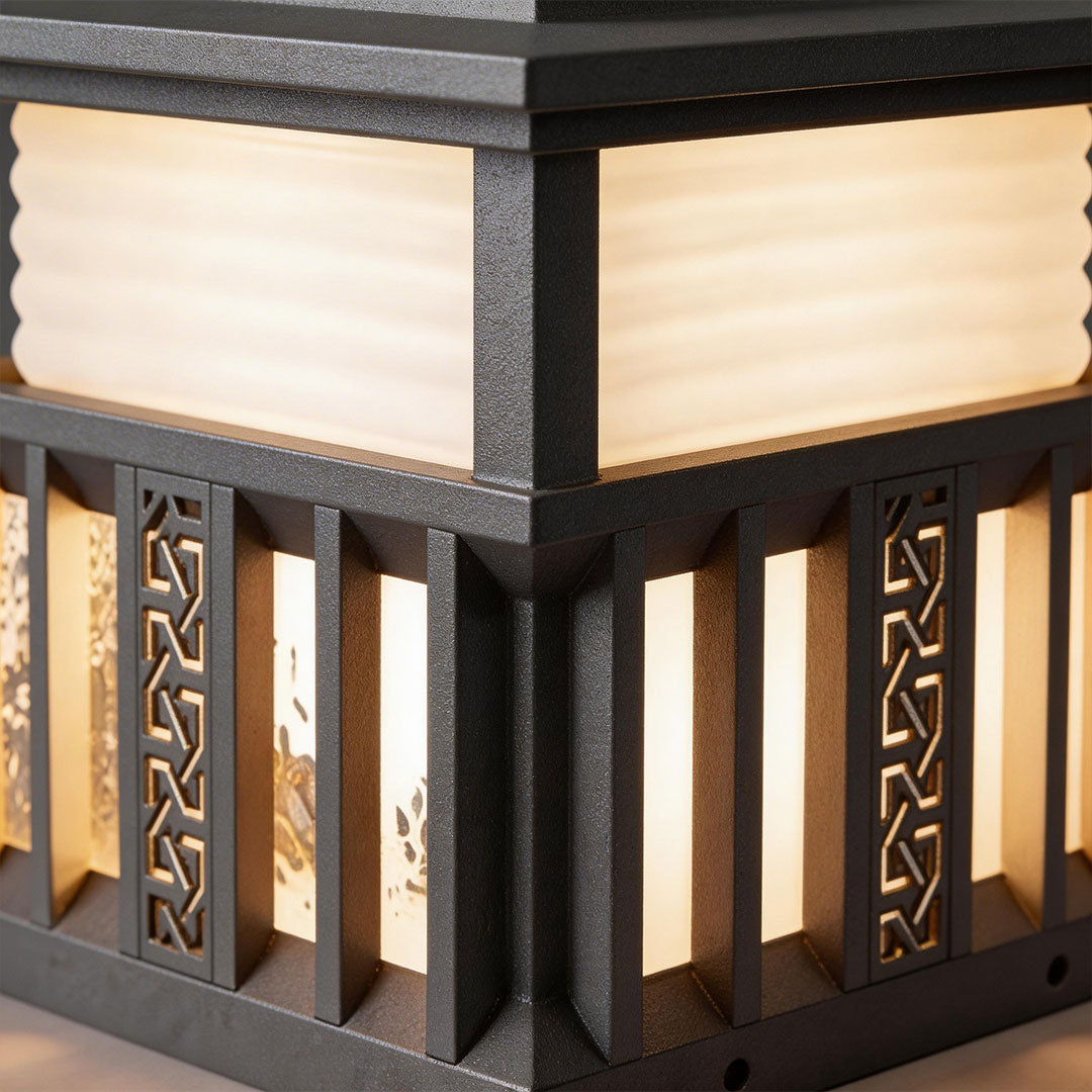 Close-up of pillar lights for house featuring detailed carvings and illuminated panels.