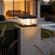 Pillar lights outdoor solar installed on modern concrete fence post with warm evening illumination.