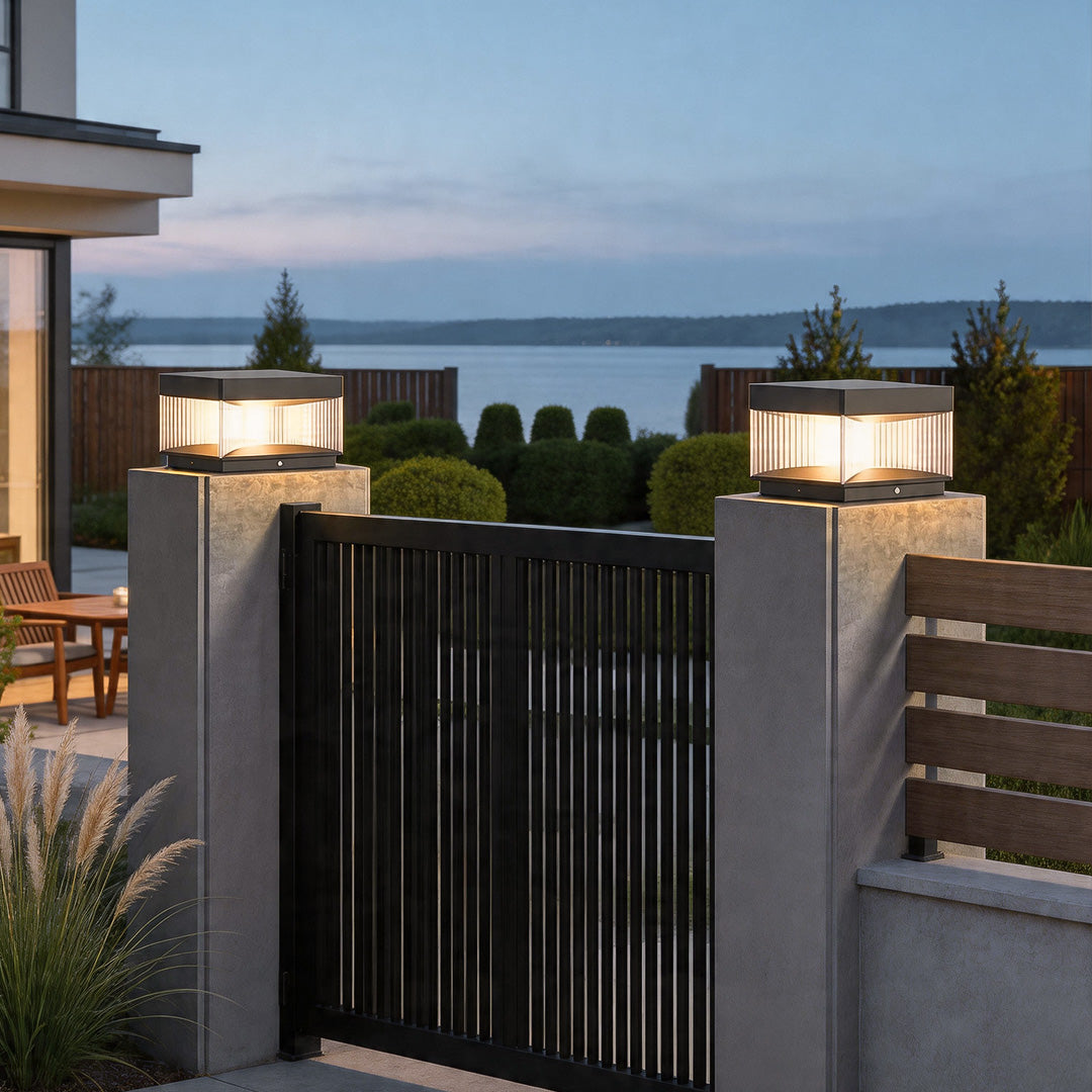 Pillar lights outdoor solar mounted on driveway gate columns creating stylish exterior lighting.