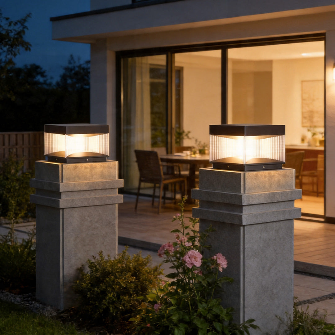 Pillar lights outdoor solar beside luxury patio entrance with elegant warm ambient lighting design.