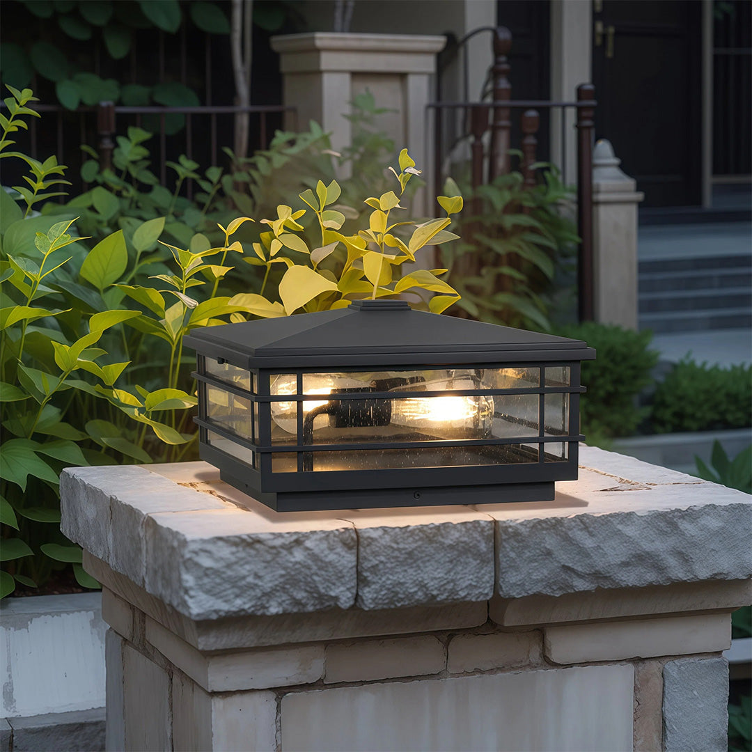 Pillar lights outdoor fixture illuminating stone pillar on contemporary patio at dusk