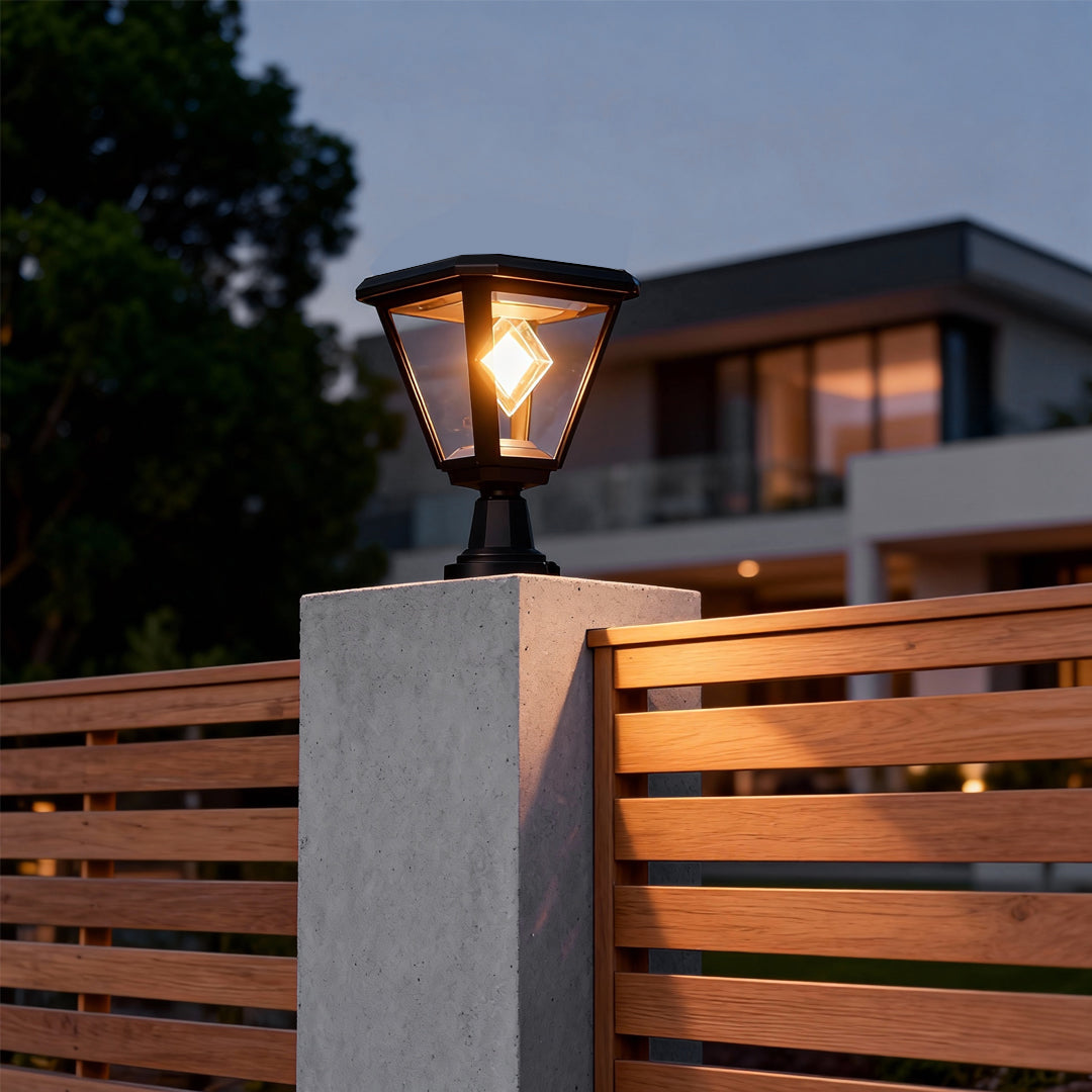 Modern pillar with mounted led post cap lights illuminating a wooden fence area in a residential yard.