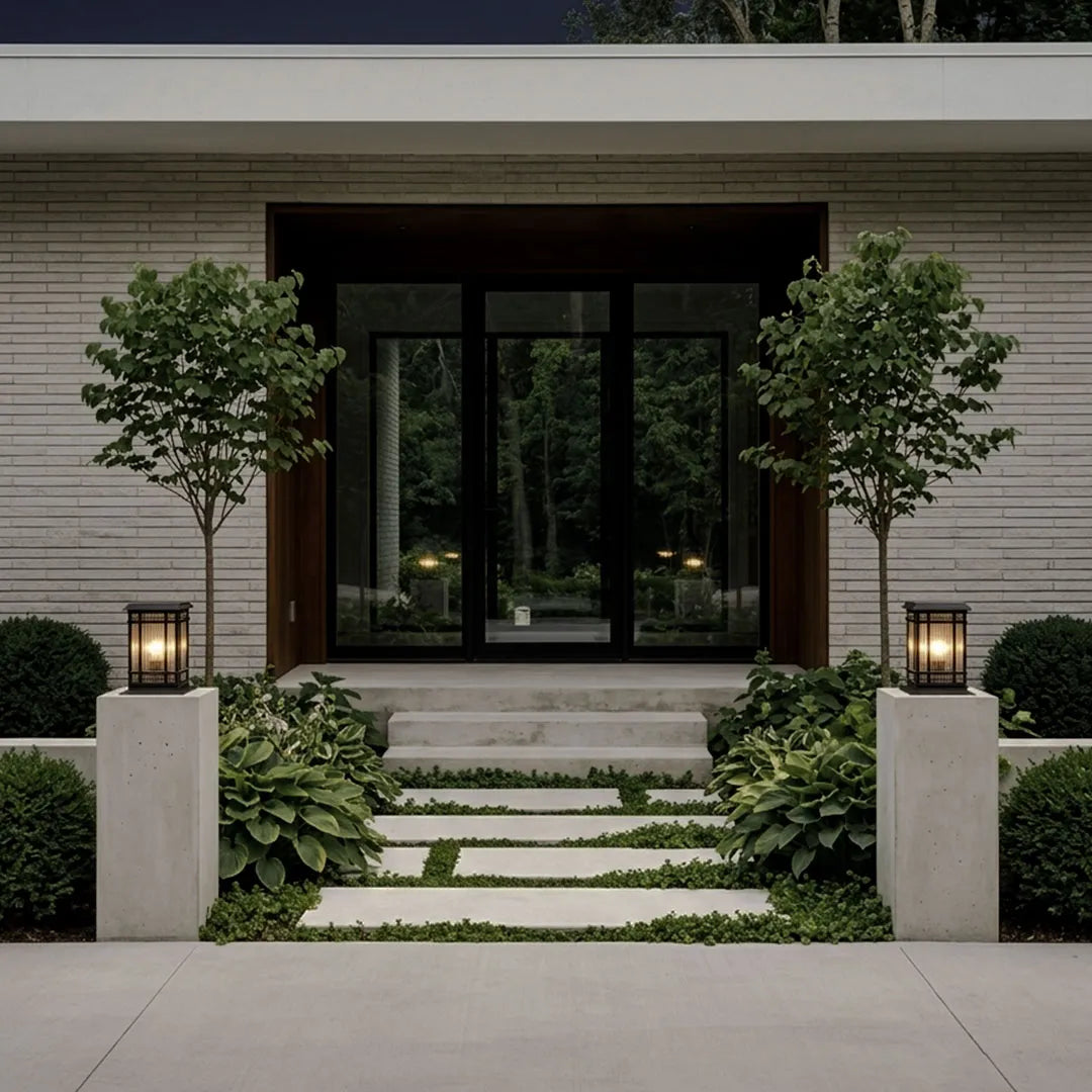 Pillar solar lights mounted on entry columns along a modern front walkway with landscaped greenery.