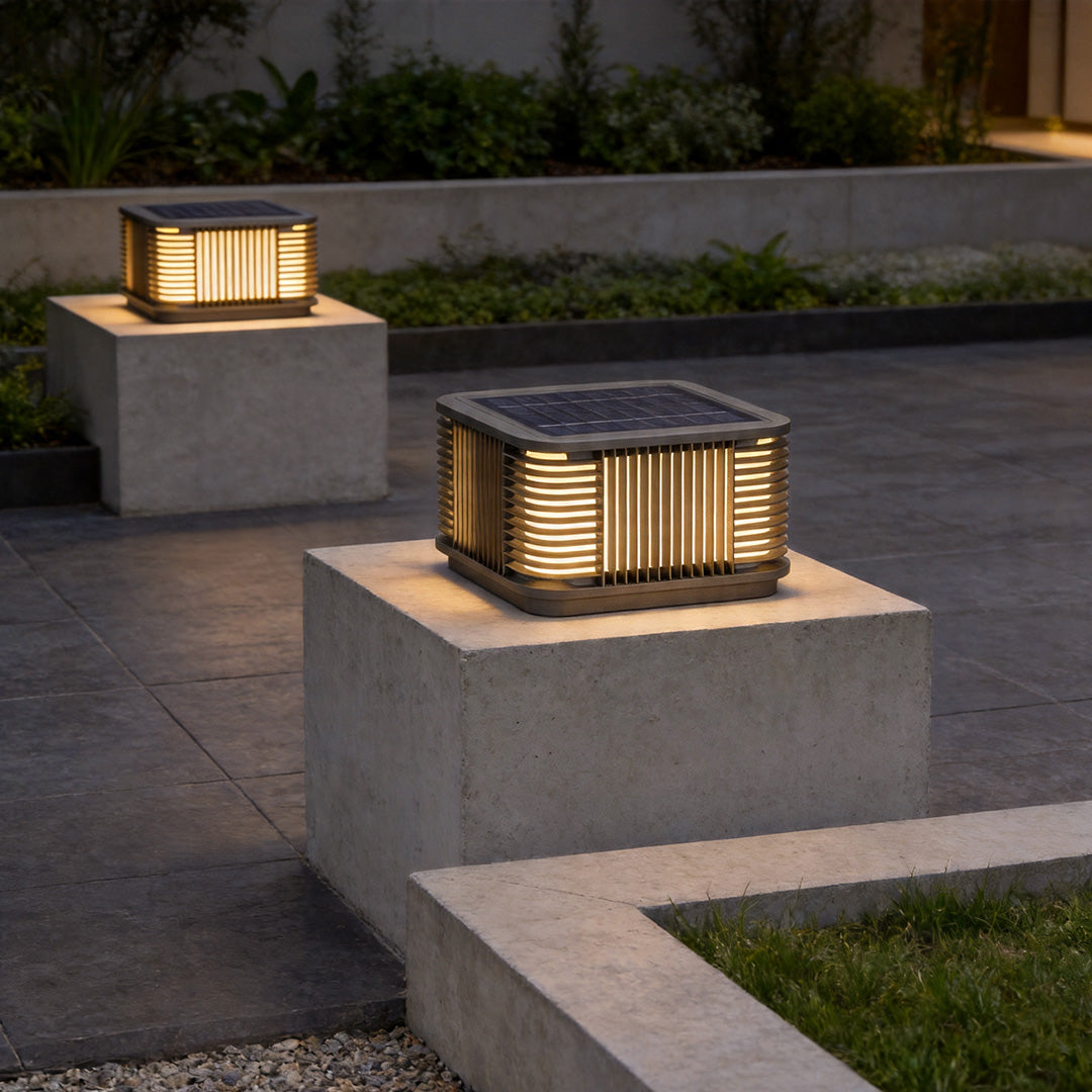 Pillar solar lights illuminating contemporary patio walls with stylish warm ambient exterior lighting.